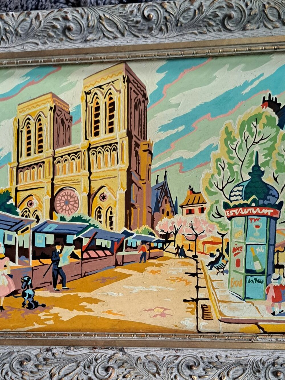 vintage paint-by-number painting depicting a scene of Paris with Notre Dame Cath